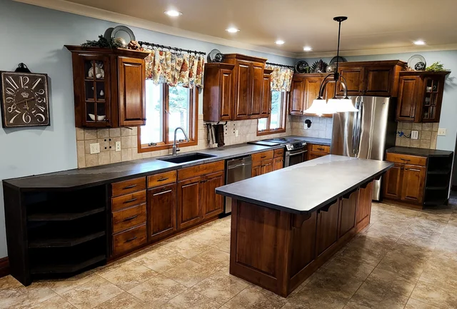 Kitchen island with warm wood cabinetry