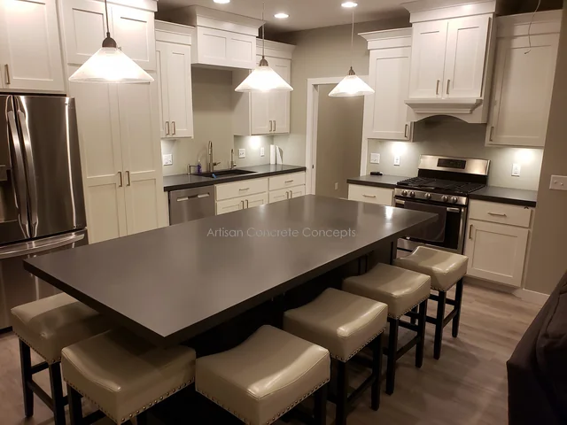 White kitchen with a dark concrete island